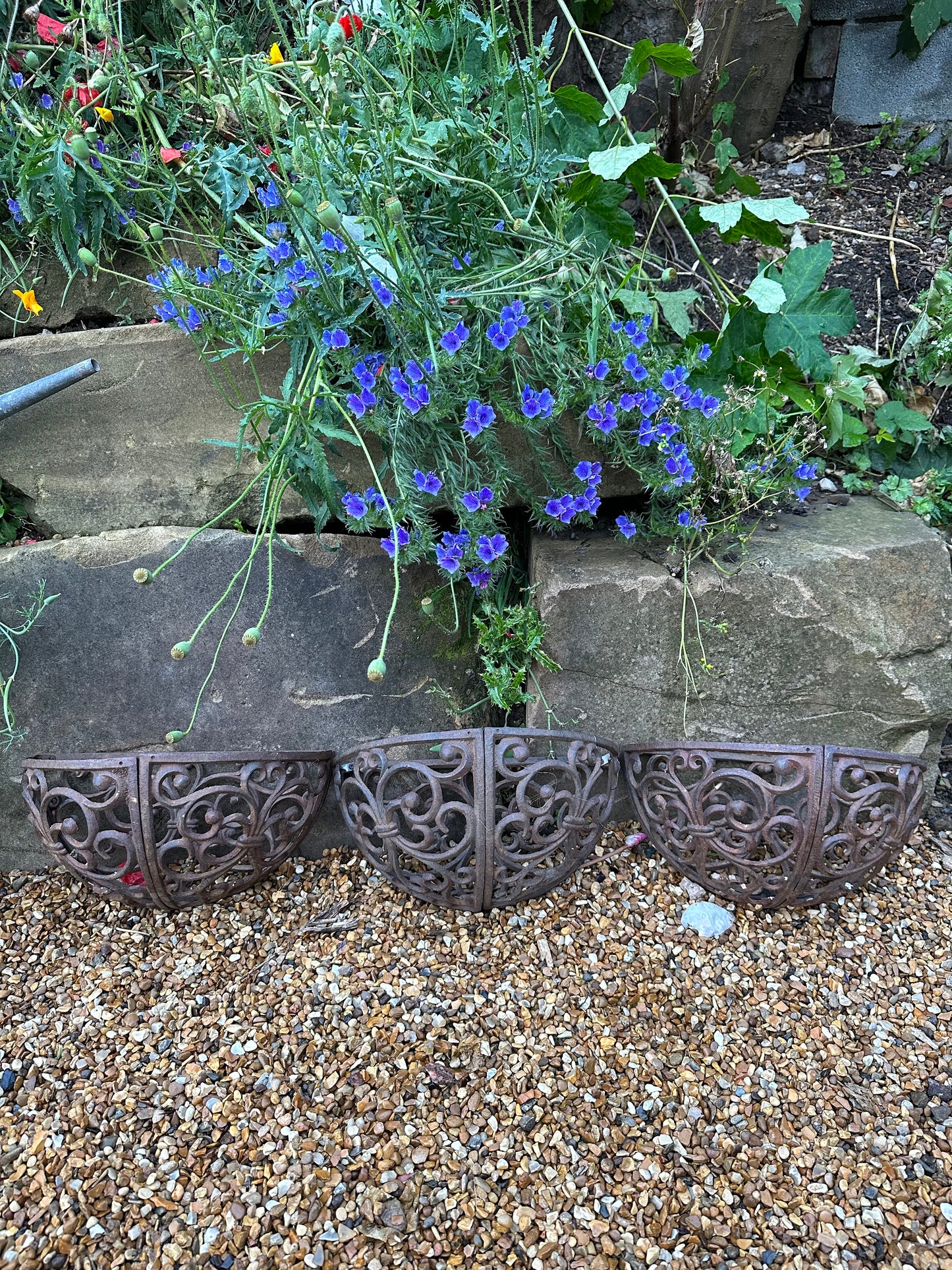 Trio of wrought iron half moon decorative vintage planters.