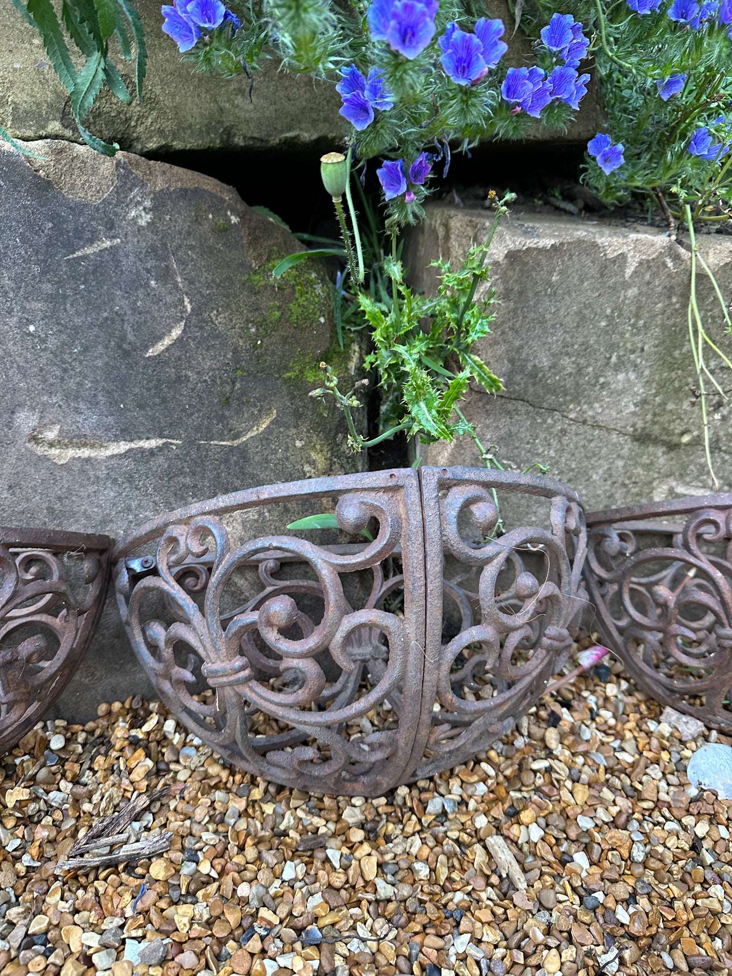 Trio of wrought iron half moon decorative vintage planters.
