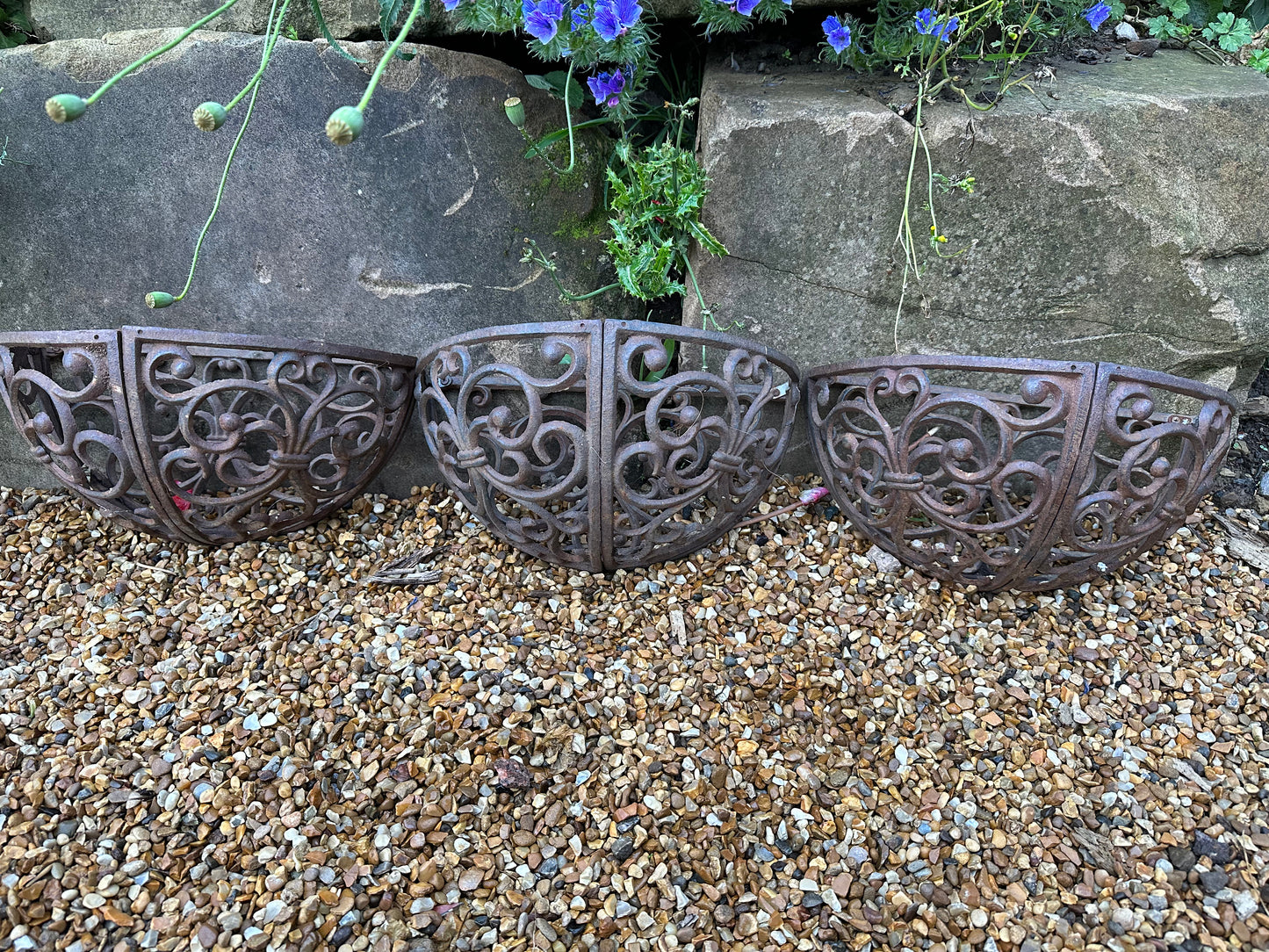 Trio of wrought iron half moon decorative vintage planters.